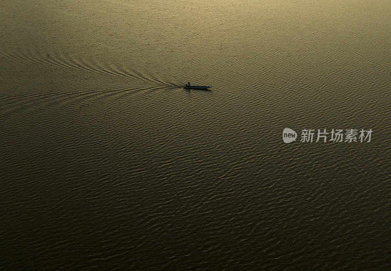 在一个阳光明媚的下午，一艘小船在金毛省的Thi Tuong泻湖上航行
